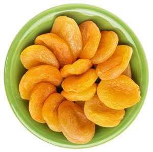 A green Fiesta ware bowl full of dried apricots